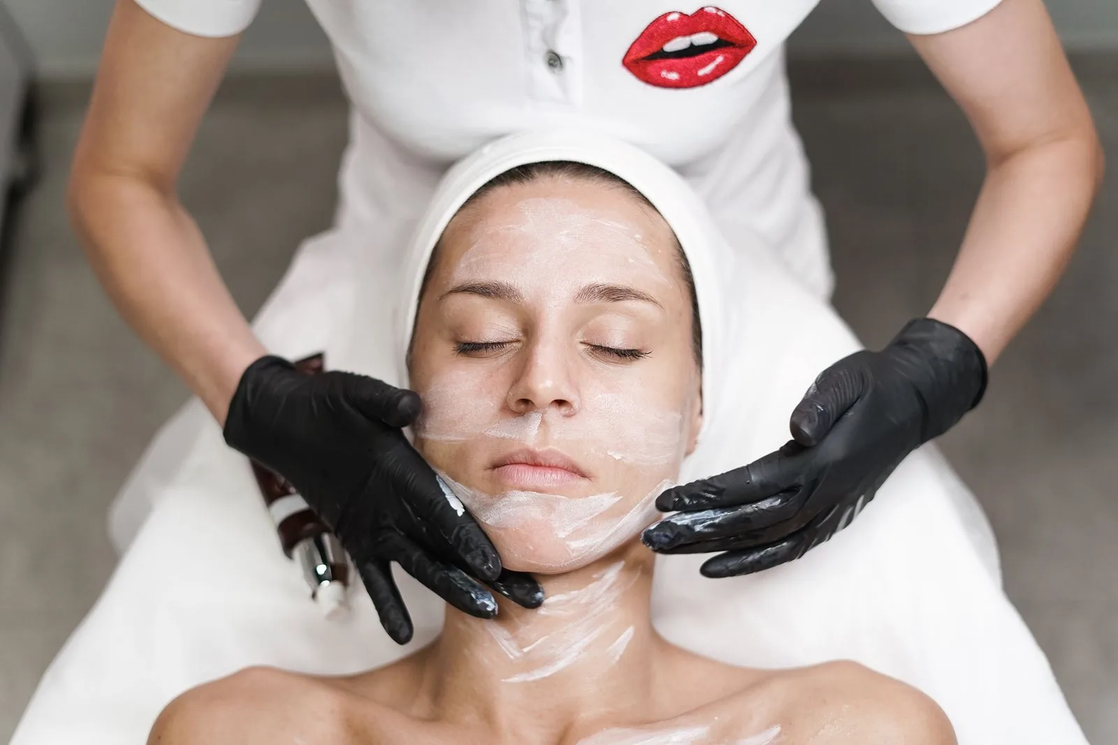 A woman relaxing during an aesthetic treatment at Just Face It MedSpa in St. Clair, MO